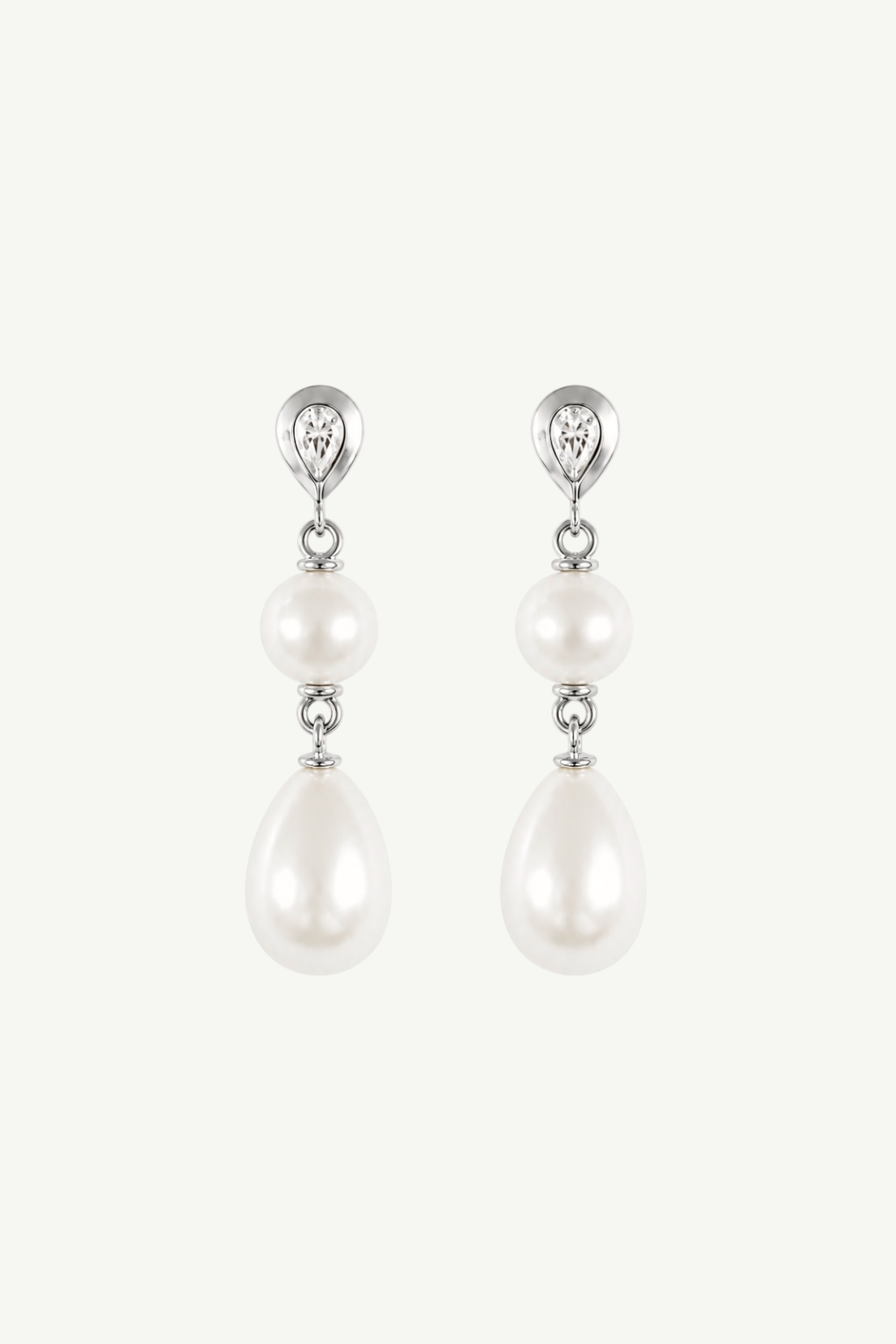 A pair of silver drop earrings featuring a teardrop-shaped pearl, a smaller round pearl, a small clear crystal, and a teardrop crystal at the top, set against a plain off-white background.