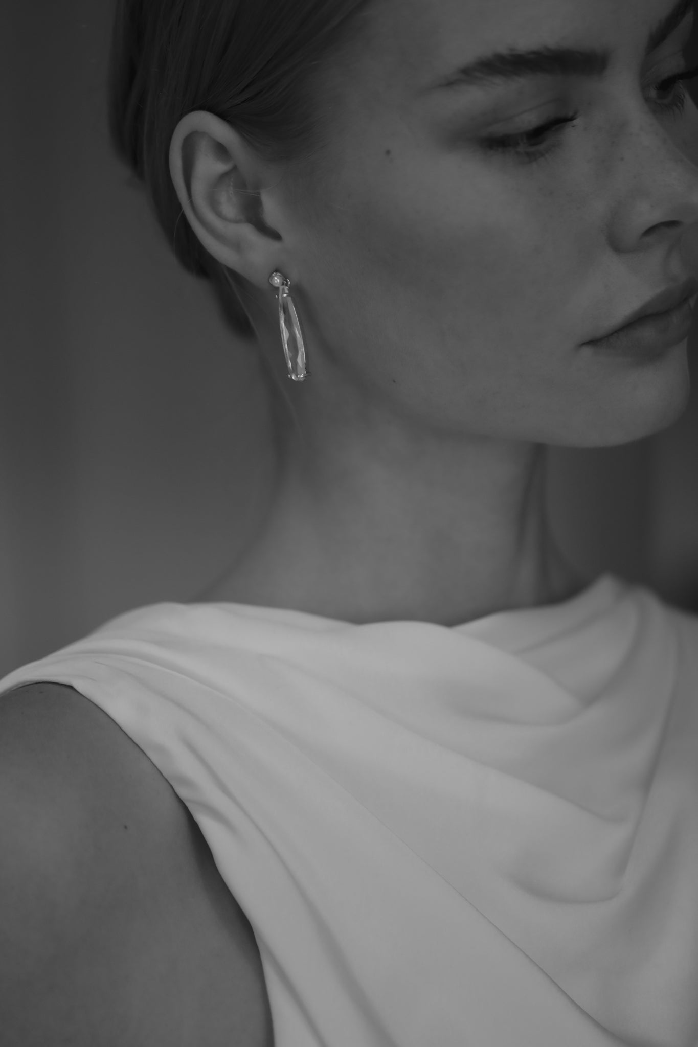 Bride wearing the Studio Bride Perla Dewdrop Crystal Earrings paired with a clean ivory wedding gown