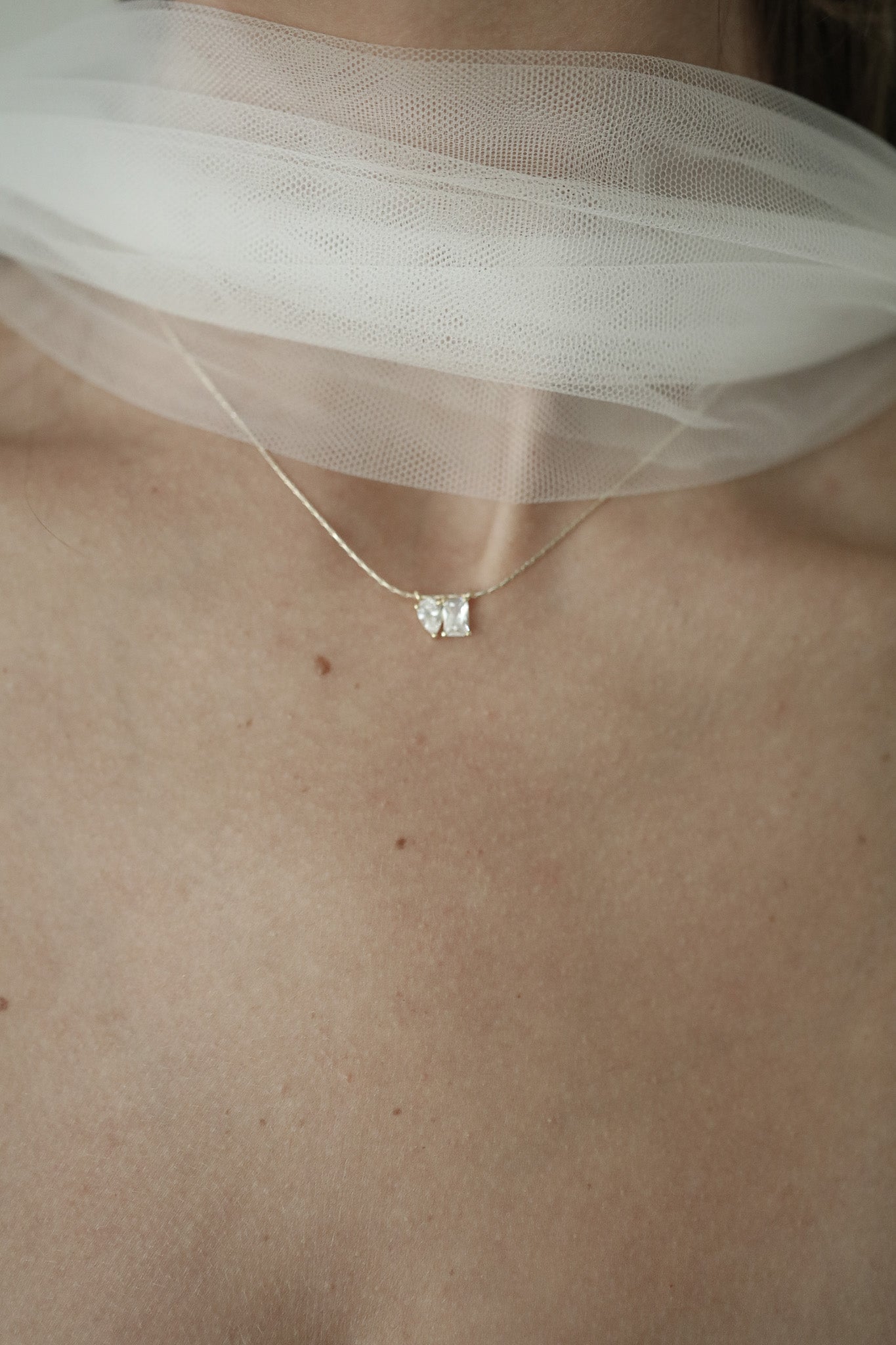 Close up photo of bride wearing a CZ pendant necklace by Studio Bride Jewelry
