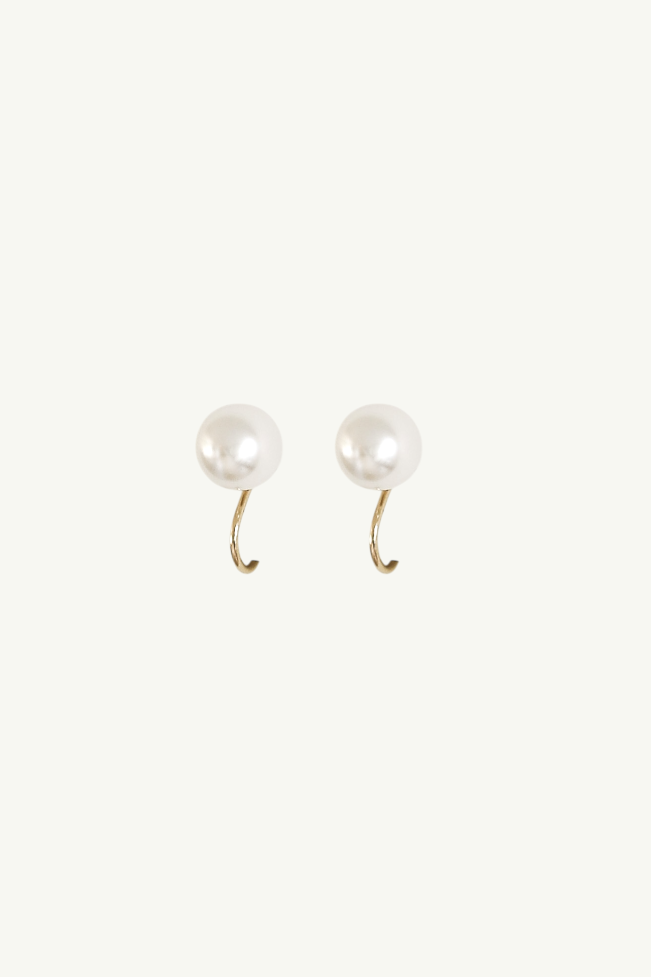 Pair of pearl stud clip on earrings on a white background
