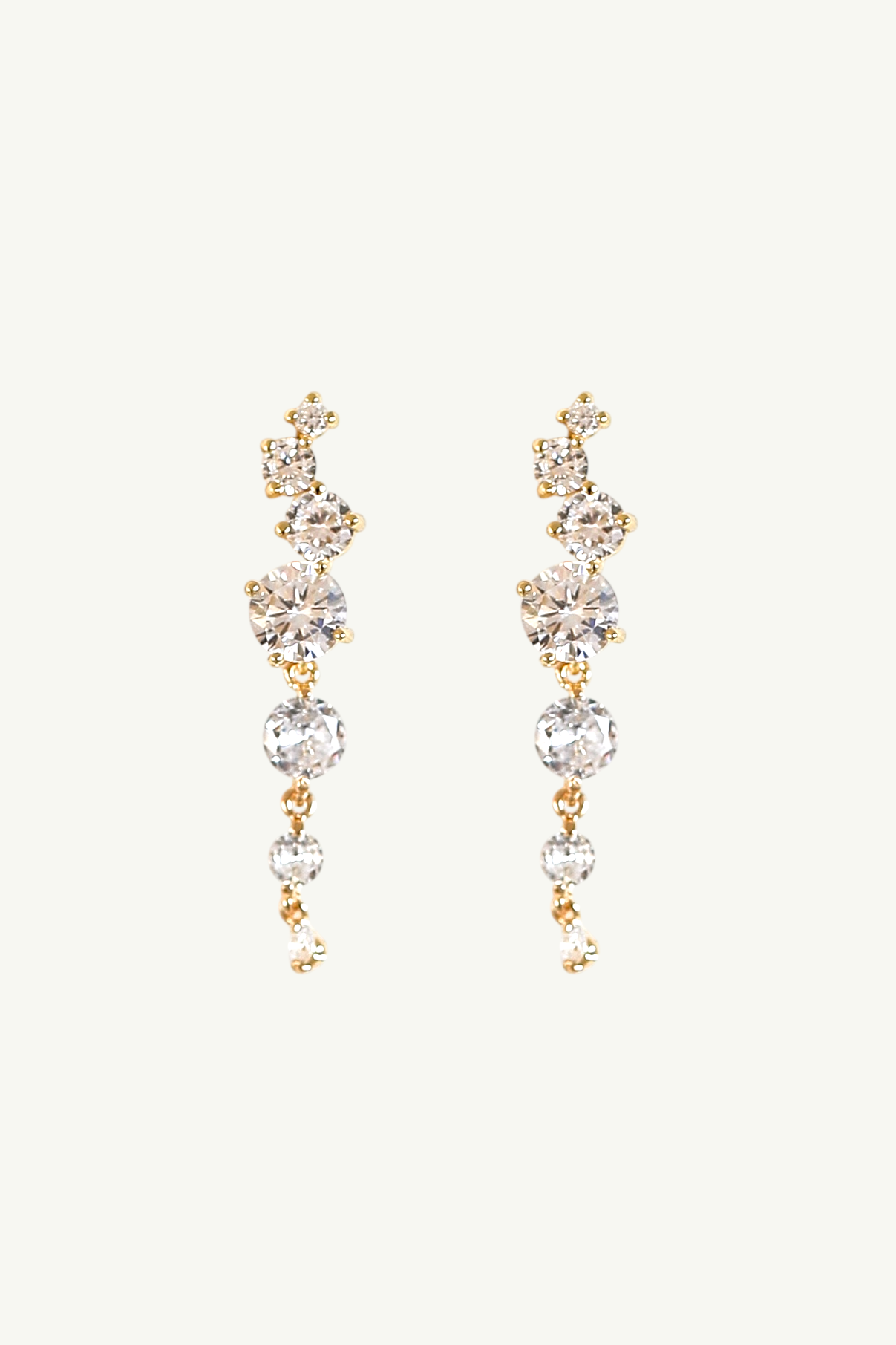 Pair of gold and crystal cluster drop earrings by Studio Bride on white background