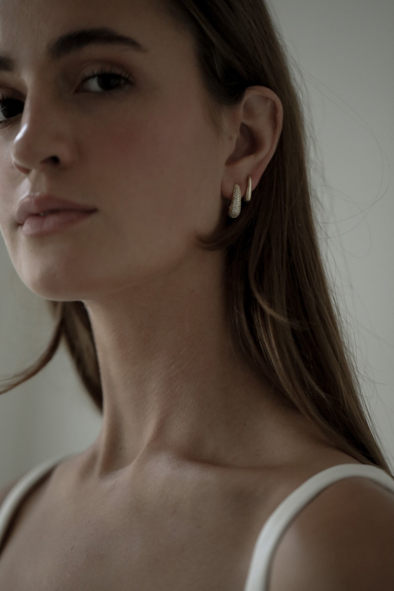 Close up photo of bride wearing the gold pave orb earring set by Studio Bride