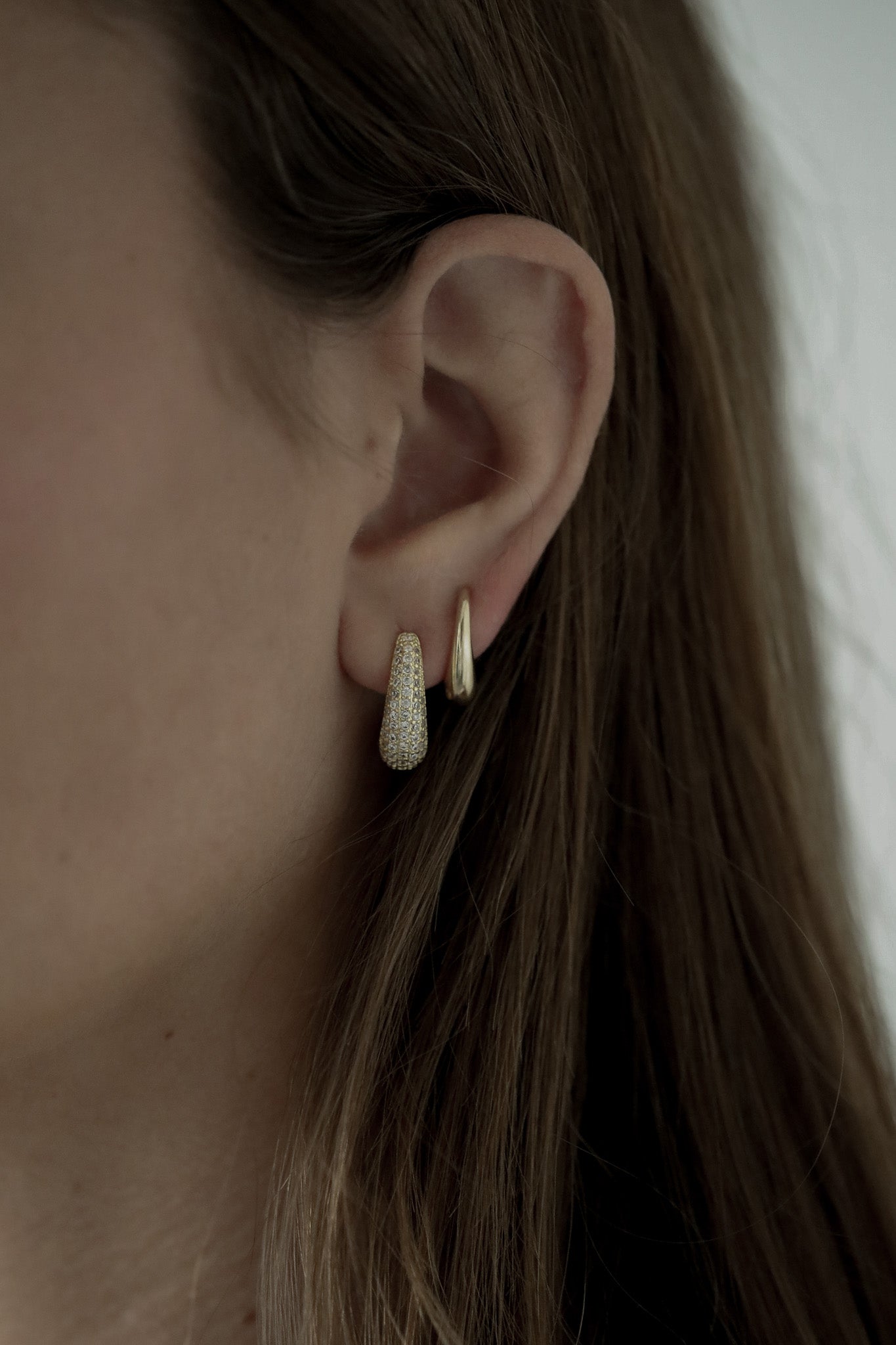 Close up photo of bride wearing the gold pave orb earring set by Studio Bride